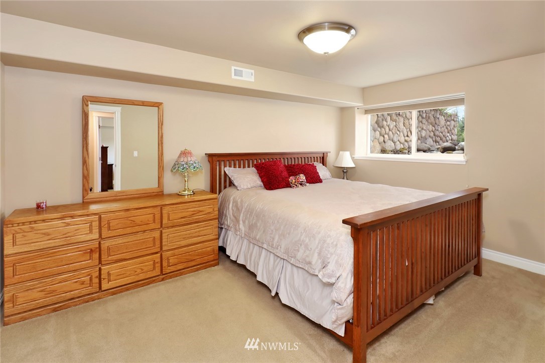 1468 East Smith Road Bellingham, WA 98226 - Photo 21 of 40 a bedroom with a bed and a dresser