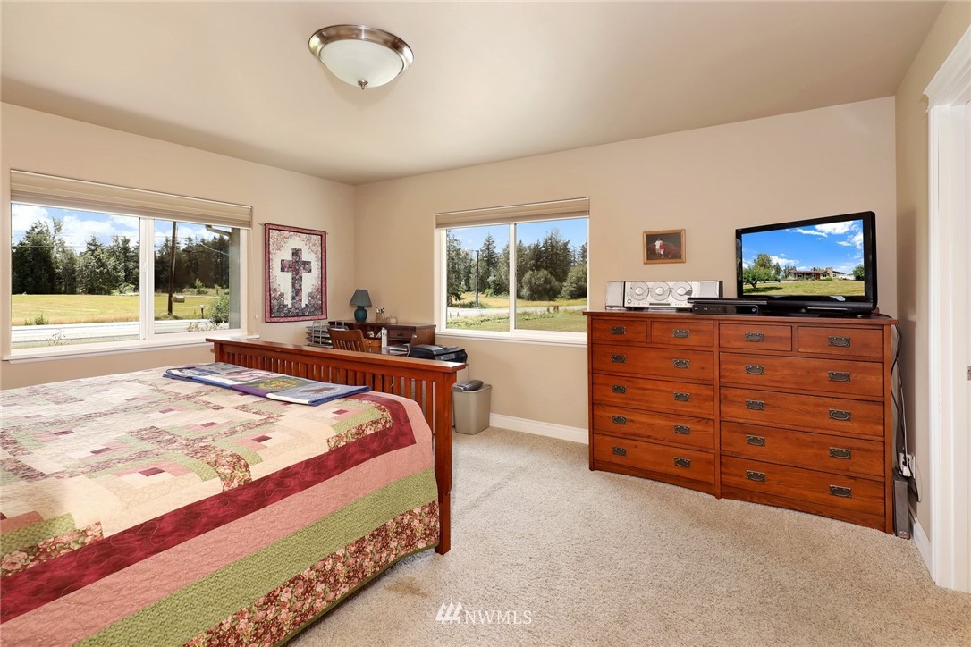 1468 East Smith Road Bellingham, WA 98226 - Photo 8 of 40 a bedroom with a bed and flat screen tv