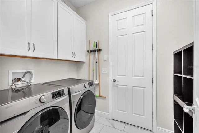 a view of a patio with table and chairs potted plants with wooden floor and fence