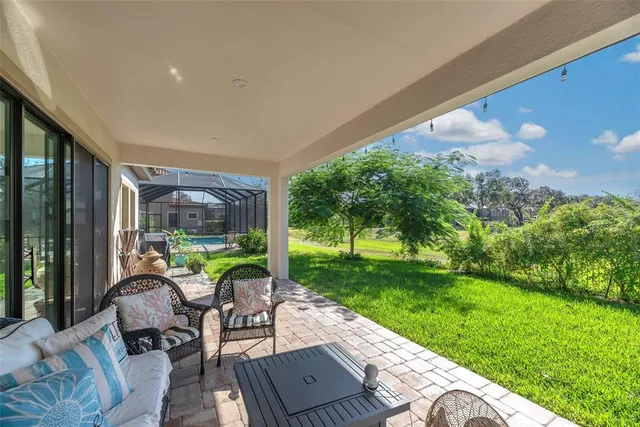 a view of a house with backyard and a tree