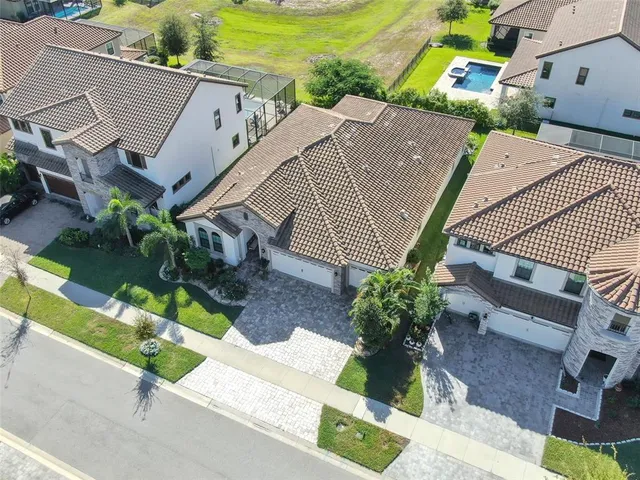 an aerial view of houses with yard