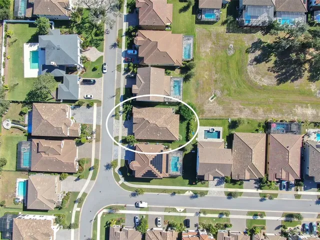 an aerial view of residential houses with outdoor space