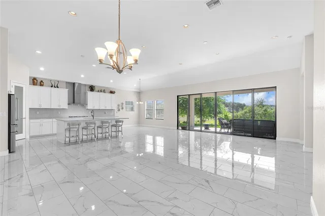 a view of living room with a large window and chandelier