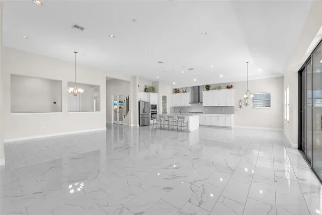 a view of a kitchen with refrigerator and cabinets