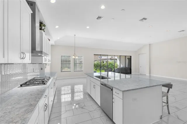 a kitchen with stainless steel appliances granite countertop a stove and a sink