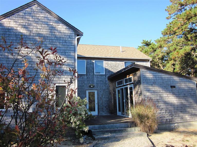21 Tecumseh Road Wellfleet, MA 02667 - Photo 1 of 33 a front view of a house with a garden