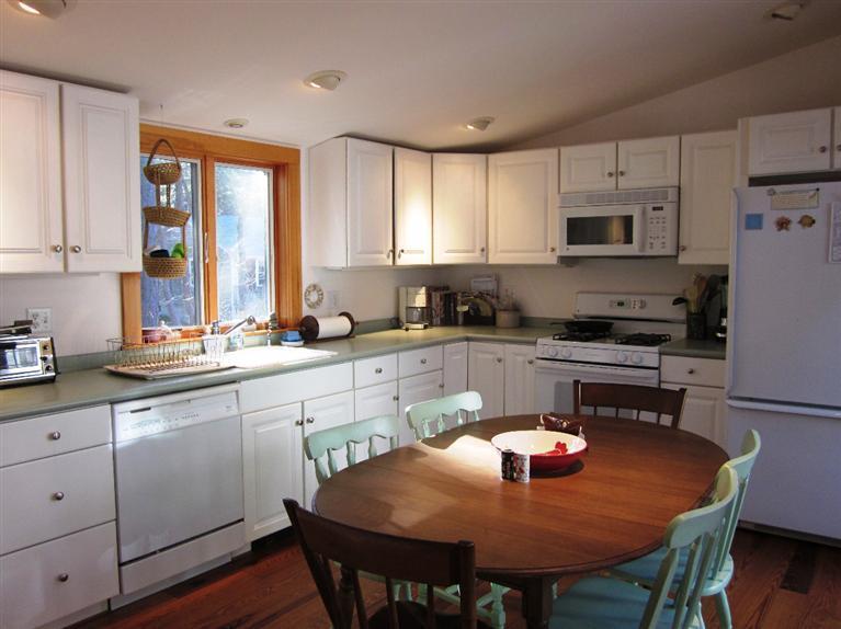 21 Tecumseh Road Wellfleet, MA 02667 - Photo 11 of 33 a kitchen with stainless steel appliances granite countertop a sink a stove a table and chairs