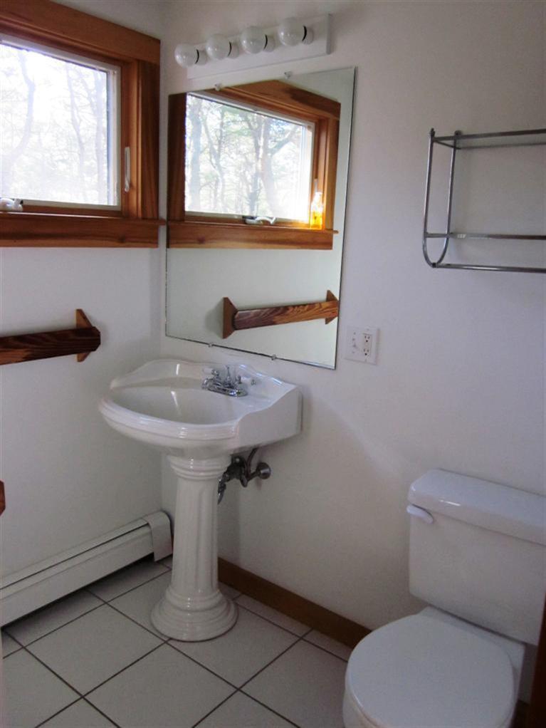21 Tecumseh Road Wellfleet, MA 02667 - Photo 14 of 33 a bathroom with a toilet sink and mirror