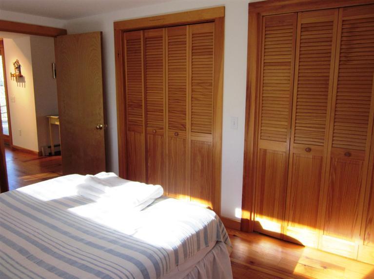 21 Tecumseh Road Wellfleet, MA 02667 - Photo 16 of 33 a bedroom with a bed and a mirror
