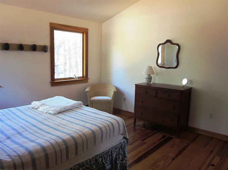 21 Tecumseh Road Wellfleet, MA 02667 - Photo 24 of 33 a bedroom with a bed and window with mirror