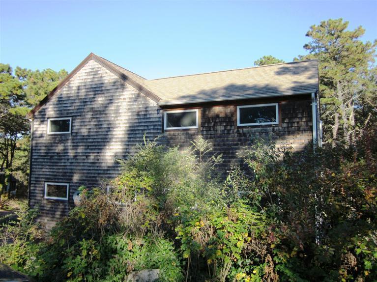 21 Tecumseh Road Wellfleet, MA 02667 - Photo 28 of 33 a view of a house with potted plants and more windows
