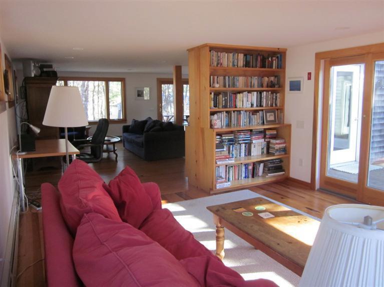 21 Tecumseh Road Wellfleet, MA 02667 - Photo 3 of 33 a living room with furniture a bookshelf and a window
