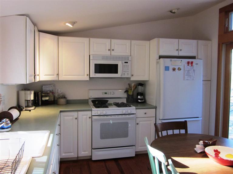 21 Tecumseh Road Wellfleet, MA 02667 - Photo 10 of 33 a kitchen with a stove a sink and a refrigerator