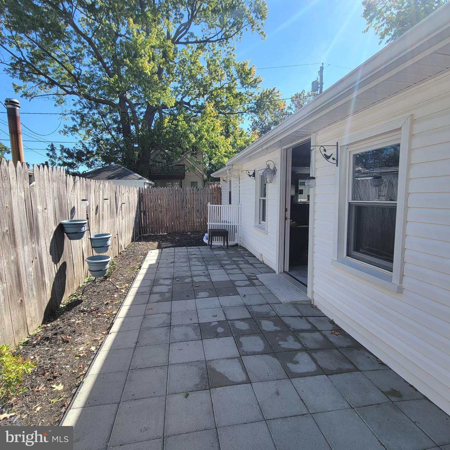 a view of a backyard with white walls
