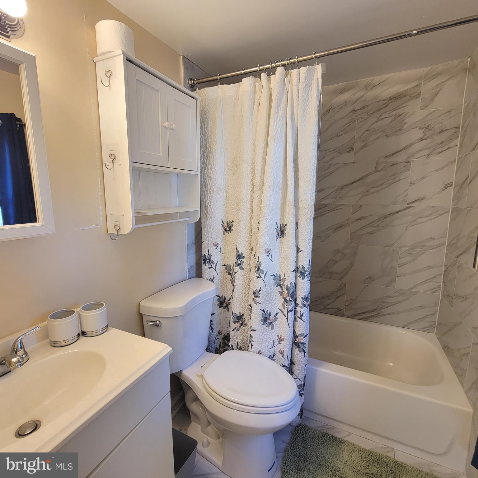 4715 Frederick Avenue Shady Side, MD 20764 - Photo 10 of 20 a bathroom with a sink toilet and shower