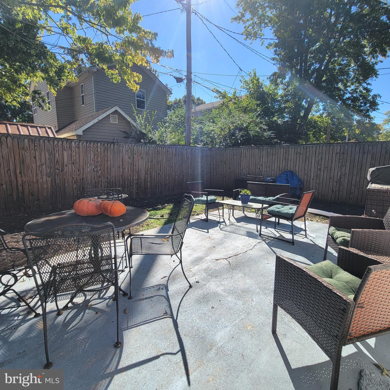 4715 Frederick Avenue Shady Side, MD 20764 - Photo 11 of 20 a view of backyard with table and chairs and potted plants