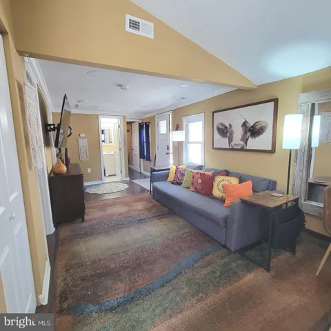 a living room with couch and a flat screen tv