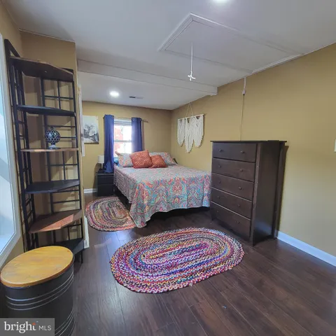 a bedroom with a large bed and a window