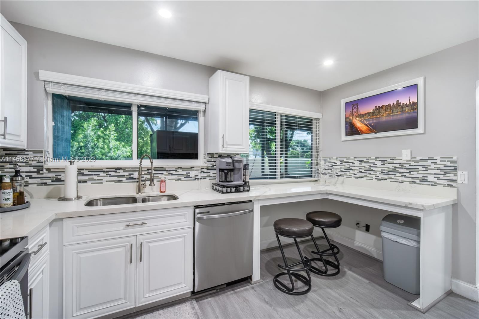 5232 Gate Lake Road, Unit 5232 Tamarac, FL 33319 - Photo 12 of 37 a kitchen with a sink a window cabinets and furniture