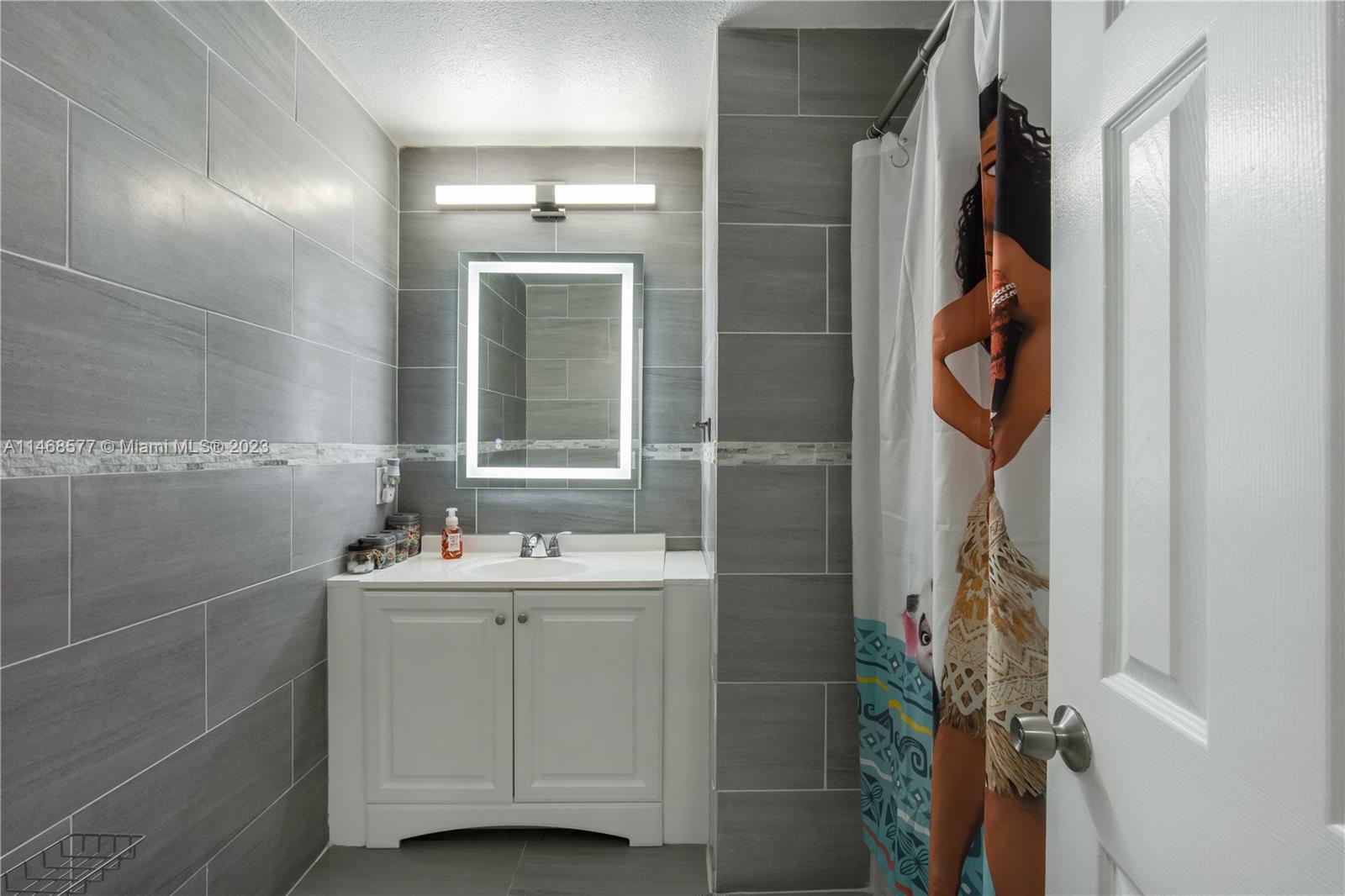 5232 Gate Lake Road, Unit 5232 Tamarac, FL 33319 - Photo 20 of 37 a bathroom with a sink and mirror