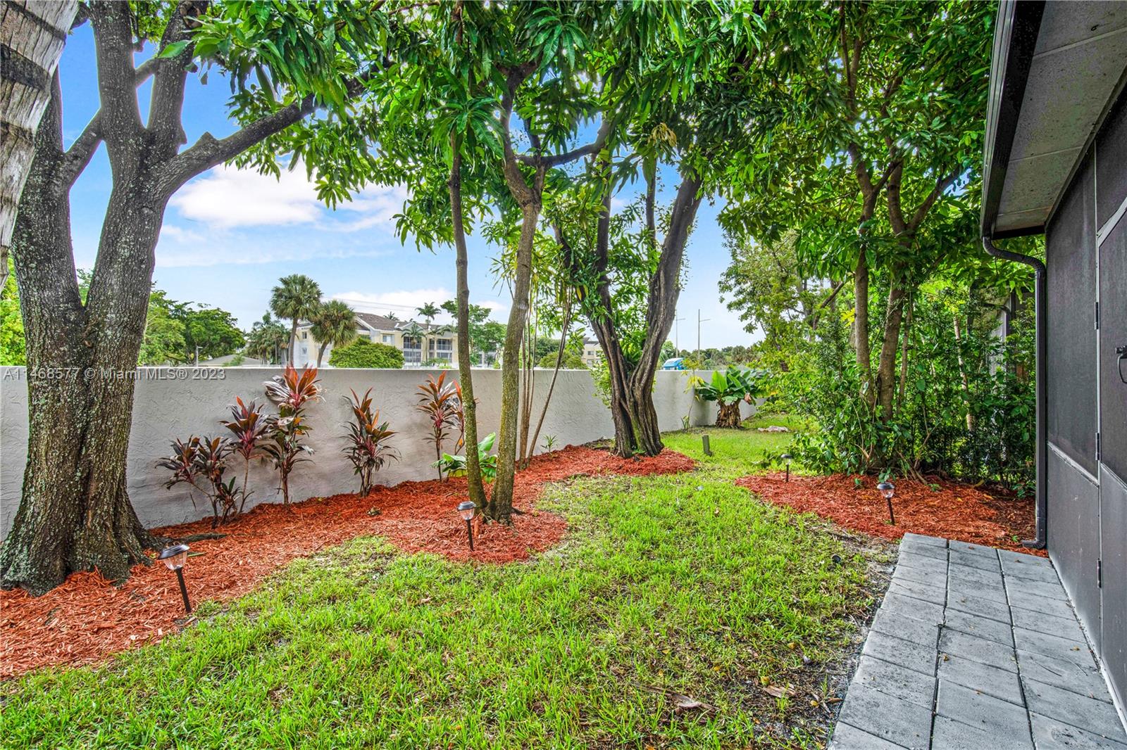 5232 Gate Lake Road, Unit 5232 Tamarac, FL 33319 - Photo 25 of 37 a view of a garden with a tree