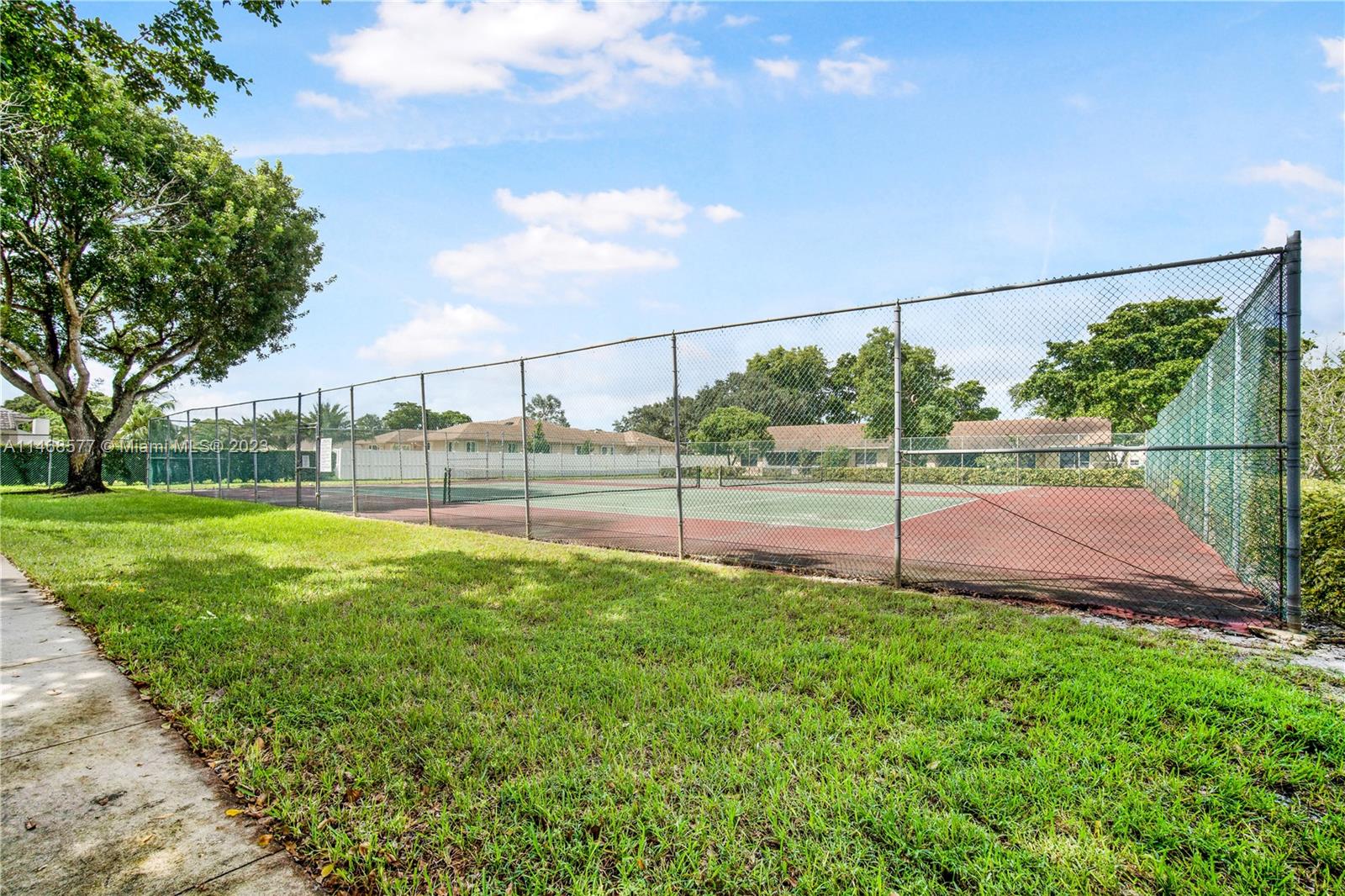5232 Gate Lake Road, Unit 5232 Tamarac, FL 33319 - Photo 29 of 37 a view of a yard and basketball court