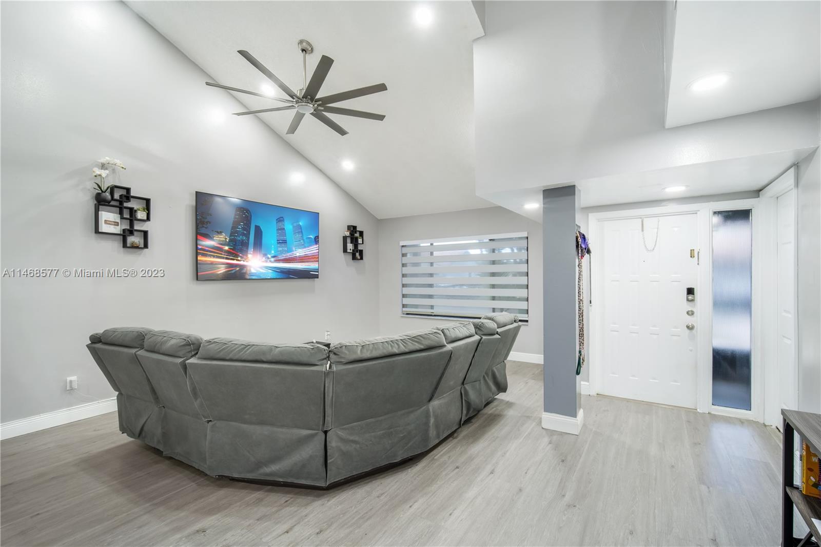 5232 Gate Lake Road, Unit 5232 Tamarac, FL 33319 - Photo 4 of 37 a living room with furniture and a ceiling fan