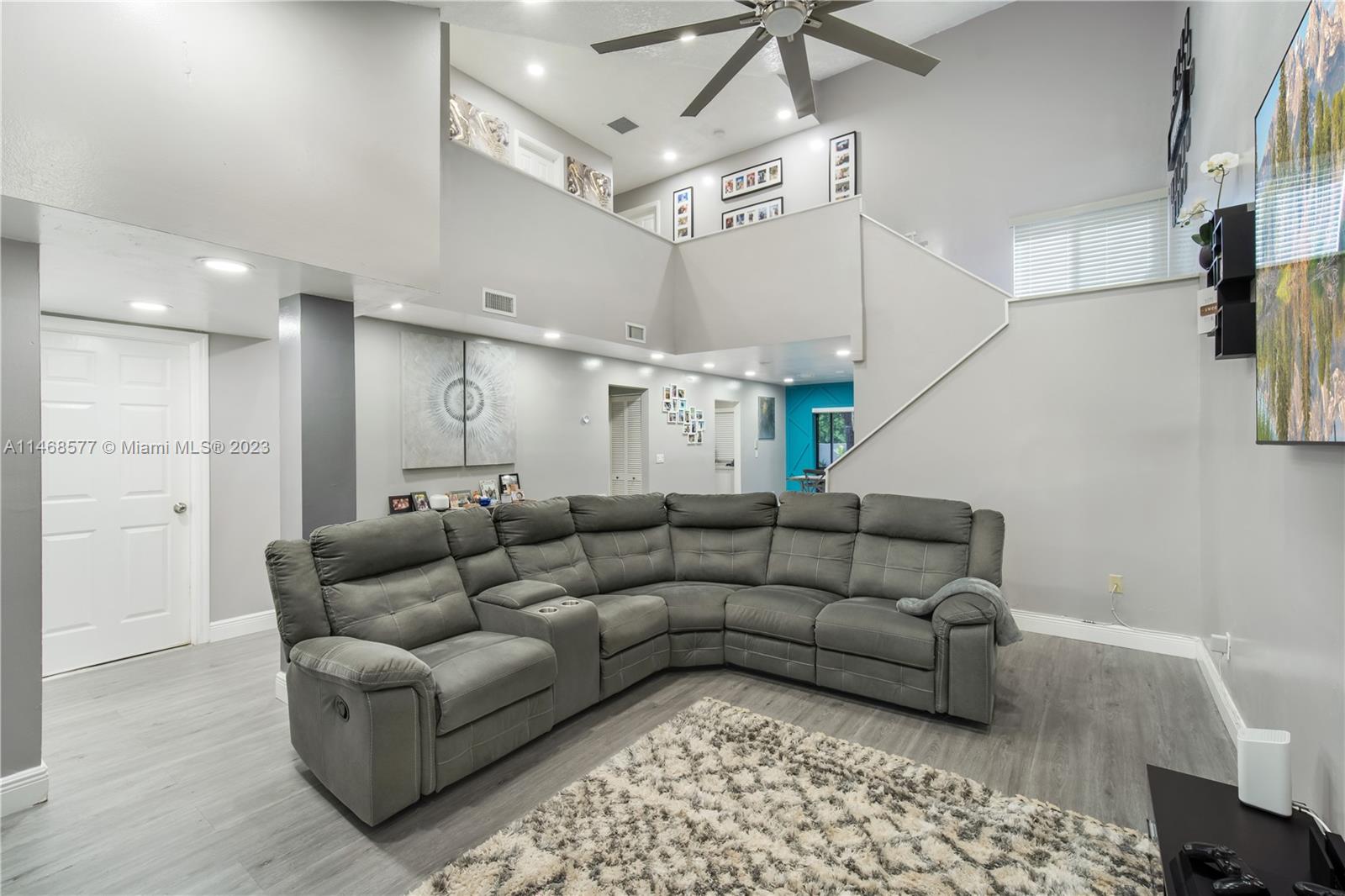 5232 Gate Lake Road, Unit 5232 Tamarac, FL 33319 - Photo 5 of 37 a living room with furniture and a chandelier