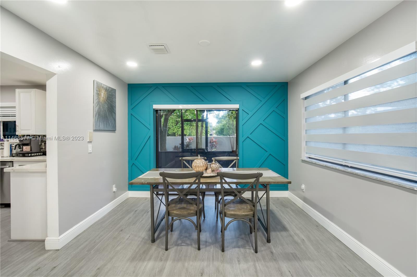 5232 Gate Lake Road, Unit 5232 Tamarac, FL 33319 - Photo 7 of 37 a view of a dining room with furniture window and wooden floor