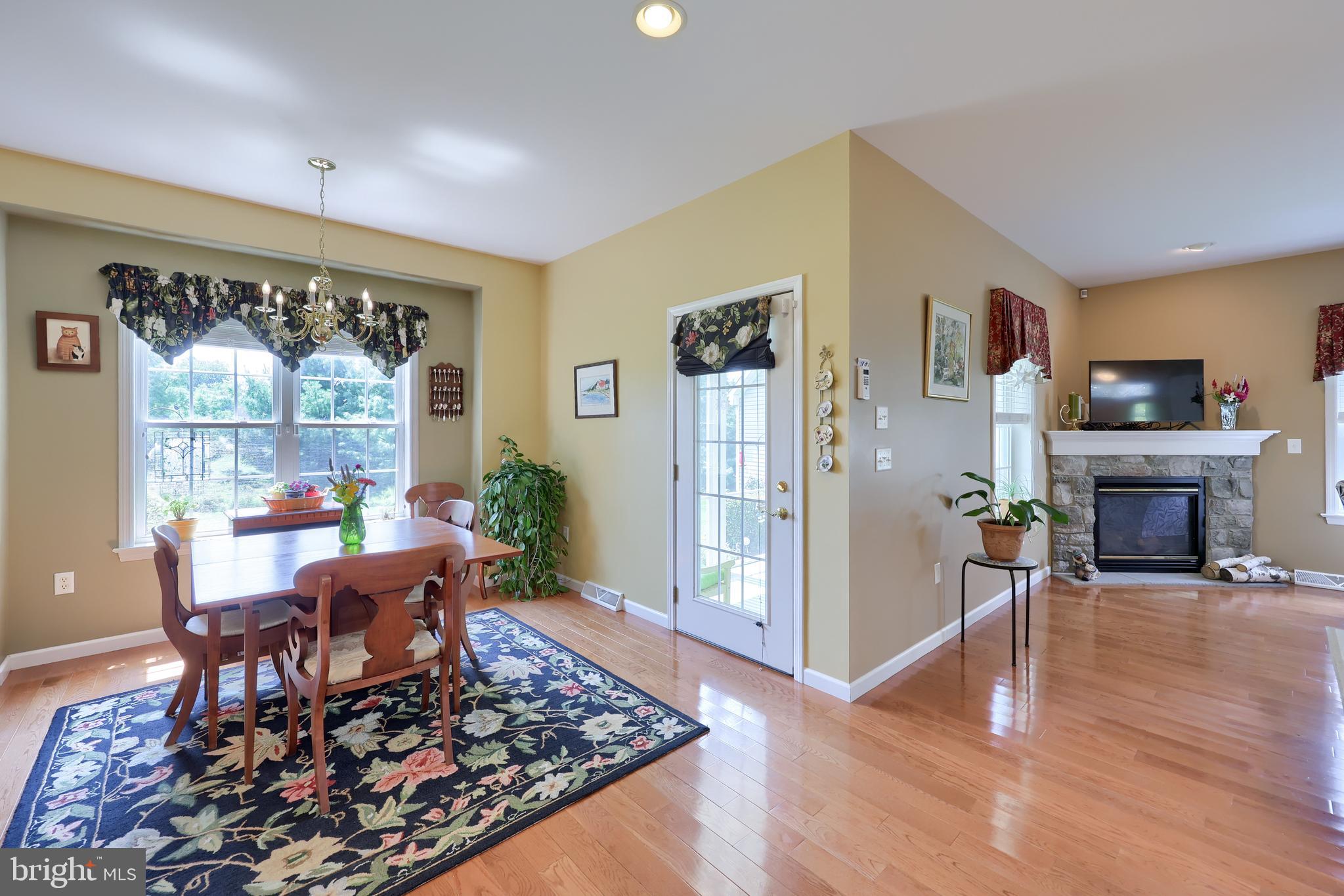 520 Providence Court Lititz, PA 17543 - Photo 11 of 44 a living room with furniture a large window and a fireplace