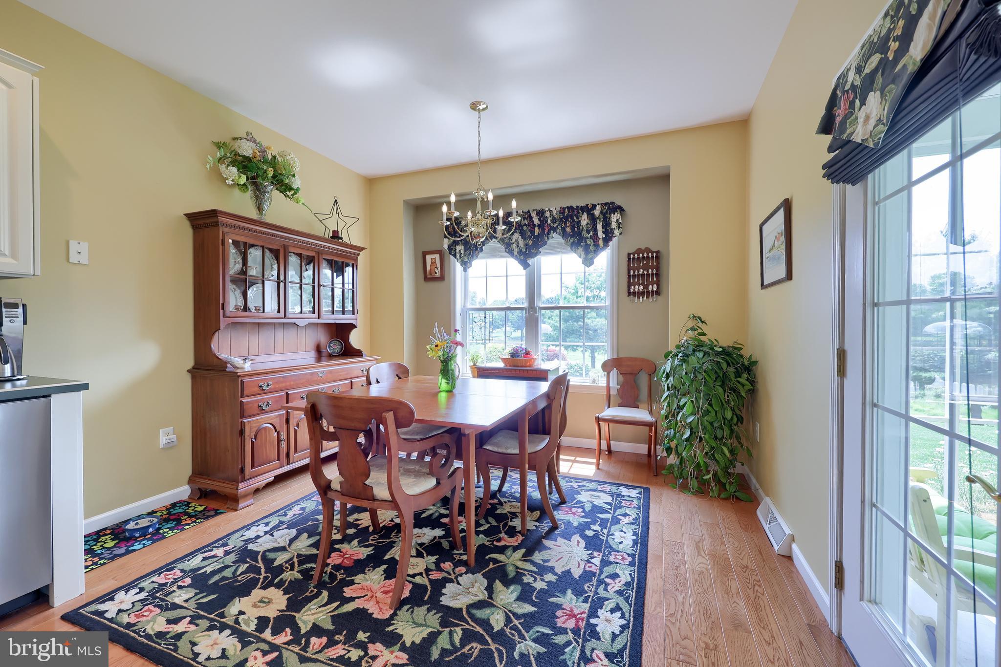 520 Providence Court Lititz, PA 17543 - Photo 12 of 44 a dining room with wooden floor a glass table and chairs