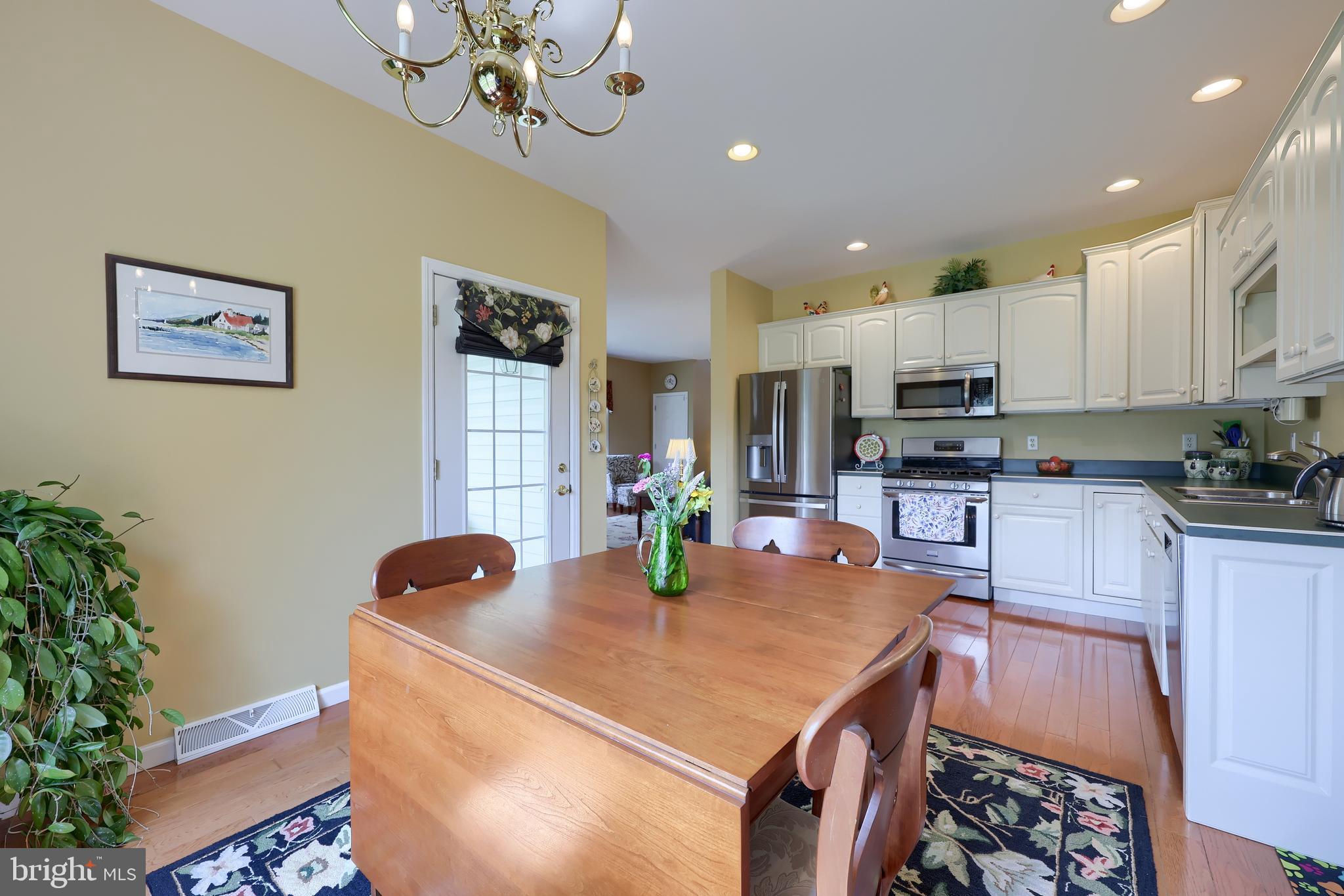 520 Providence Court Lititz, PA 17543 - Photo 13 of 44 a kitchen with stainless steel appliances granite countertop a sink a stove a dining table and chairs