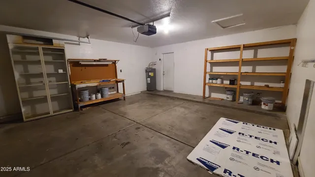 a view of room with wooden floor and furniture