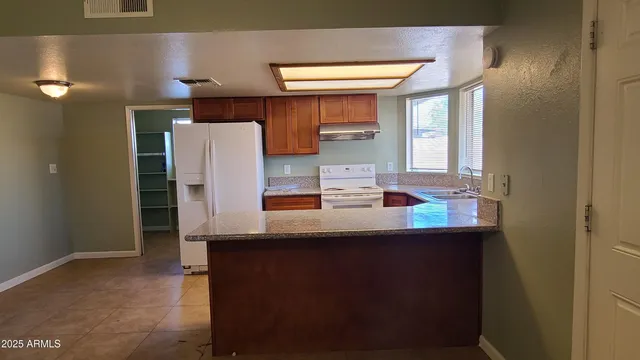 a kitchen with stainless steel appliances a sink and a refrigerator