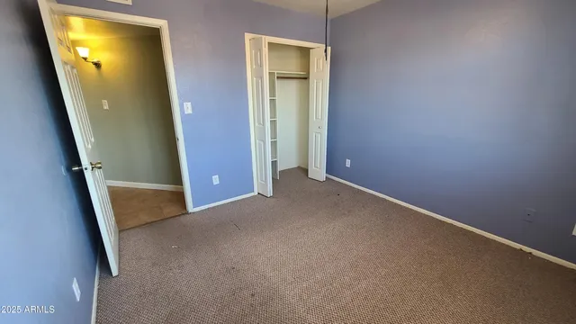 an empty room with mirror and entrance