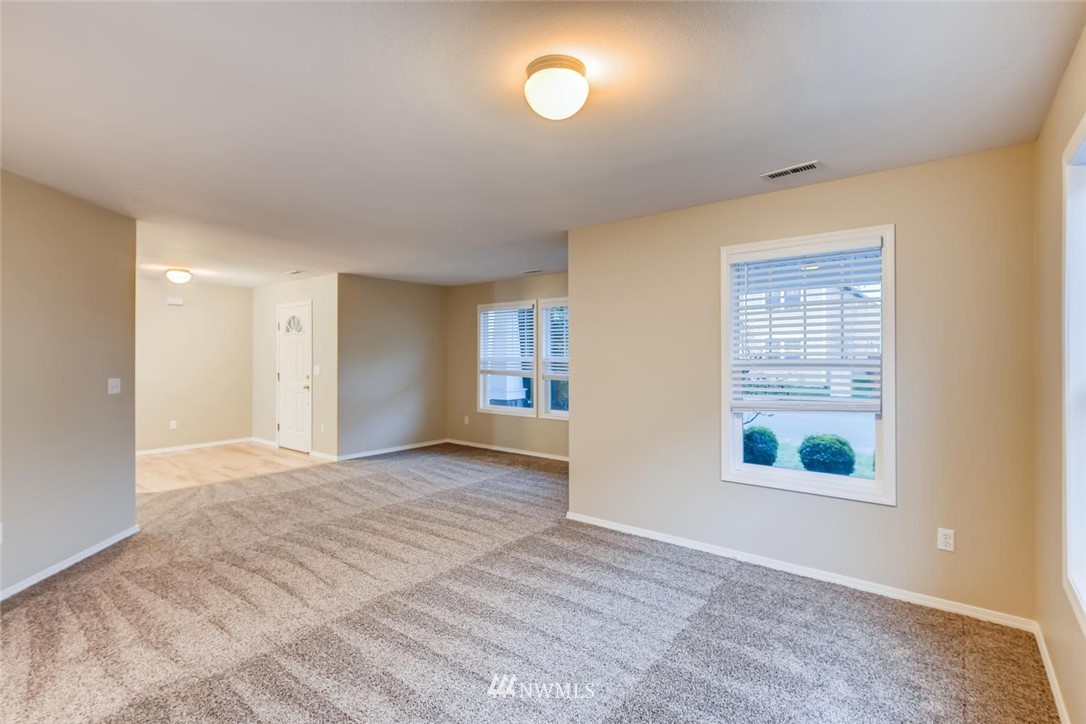 309 Index Place Southeast Renton, WA 98056 - Photo 26 of 28 a view of an empty room with a window and wooden floor