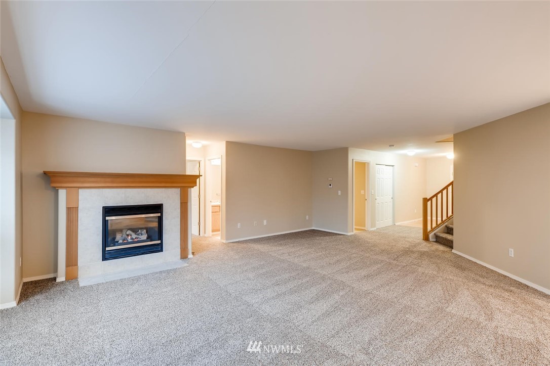 309 Index Place Southeast Renton, WA 98056 - Photo 4 of 28 an empty room with a fireplace and window