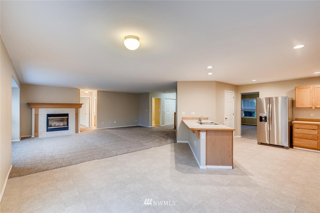 309 Index Place Southeast Renton, WA 98056 - Photo 6 of 28 a view of a kitchen with a sink and a fireplace