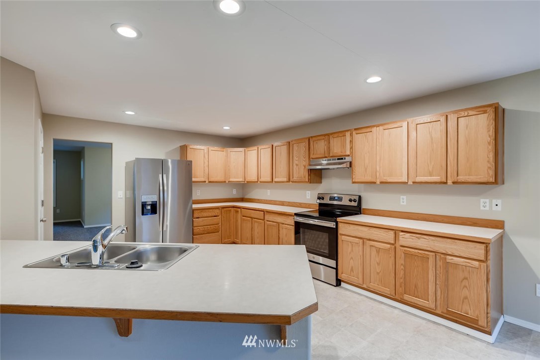 309 Index Place Southeast Renton, WA 98056 - Photo 8 of 28 a large kitchen with kitchen island a sink stainless steel appliances and cabinets