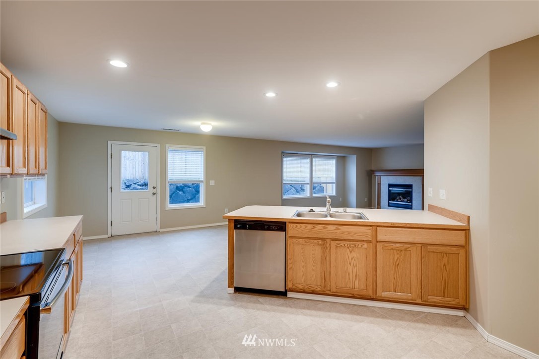 309 Index Place Southeast Renton, WA 98056 - Photo 9 of 28 a kitchen with kitchen island a sink stove and refrigerator