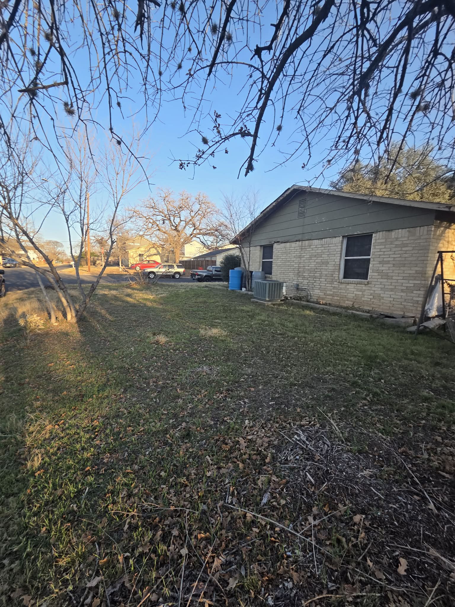 1308 Astor Place Austin, TX 78721 - Photo 2 of 6 View of property exterior featuring brick siding and a lawn