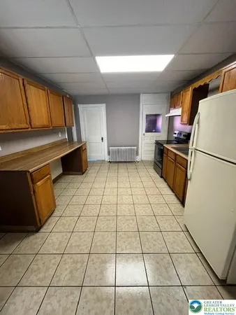 a kitchen with a sink a stove and a refrigerator