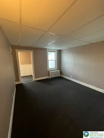 an empty room with a empty space and windows