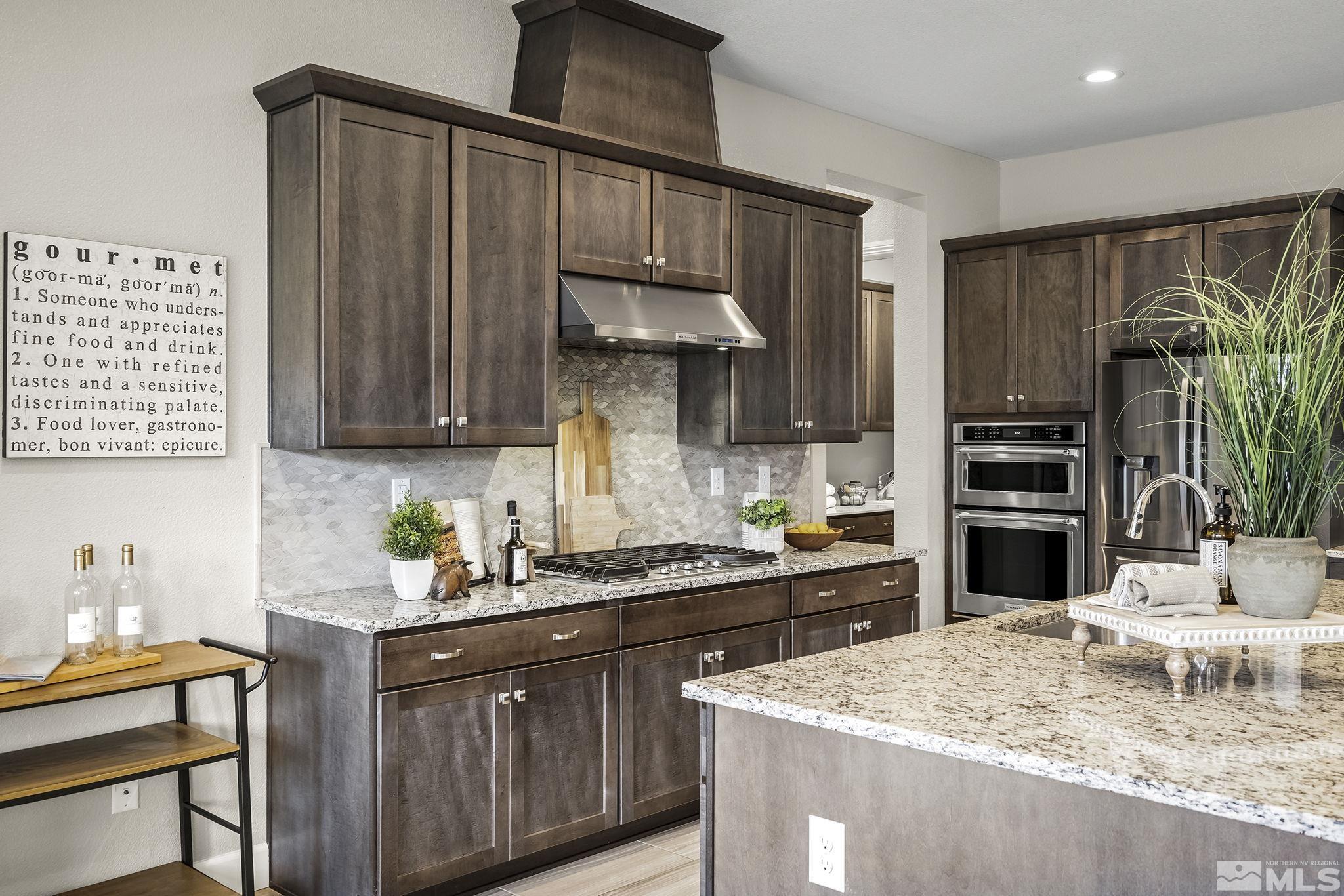 326 Ironway Court Reno, NV 89521 - Photo 14 of 37 a kitchen with stainless steel appliances granite countertop a sink refrigerator and cabinets