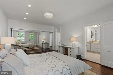 a spacious bedroom with a bed and a lamp