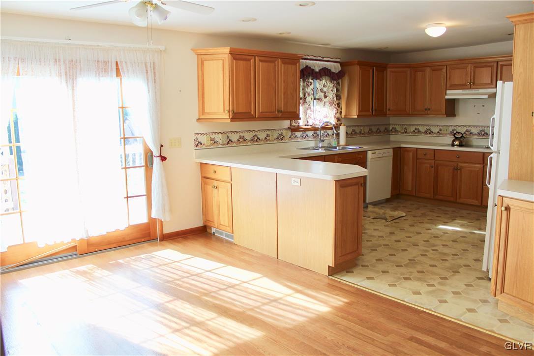 3918 Mechanicsville Road Whitehall, PA 18052 - Photo 6 of 25 a kitchen with a stove a sink and a refrigerator
