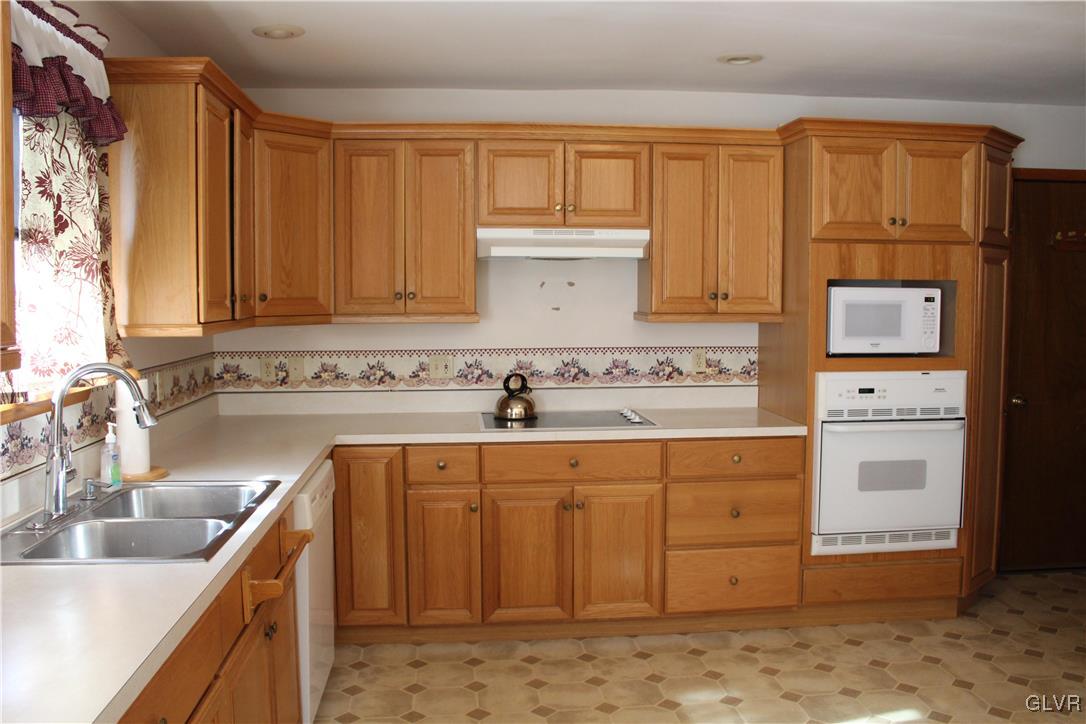3918 Mechanicsville Road Whitehall, PA 18052 - Photo 8 of 25 a kitchen with a sink and cabinets