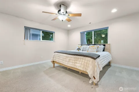 a bed sitting in a bedroom next to a window