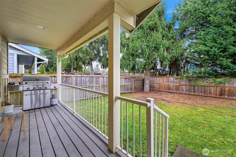 a view of a balcony with floor to ceiling window and wooden fence