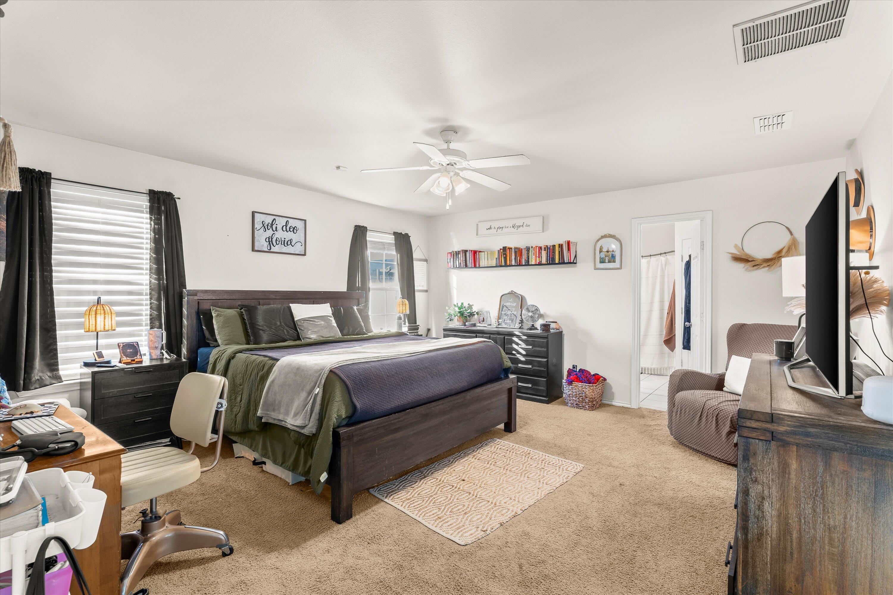 6513 85th Street Lubbock, TX 79424 - Photo 12 of 22 a bedroom with bed and a flat screen tv